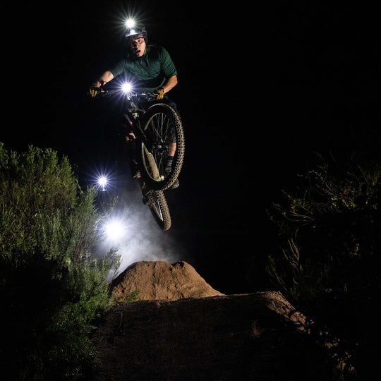 mtb getting air at night with niterider lumina headlight secured with heavy duty mounting